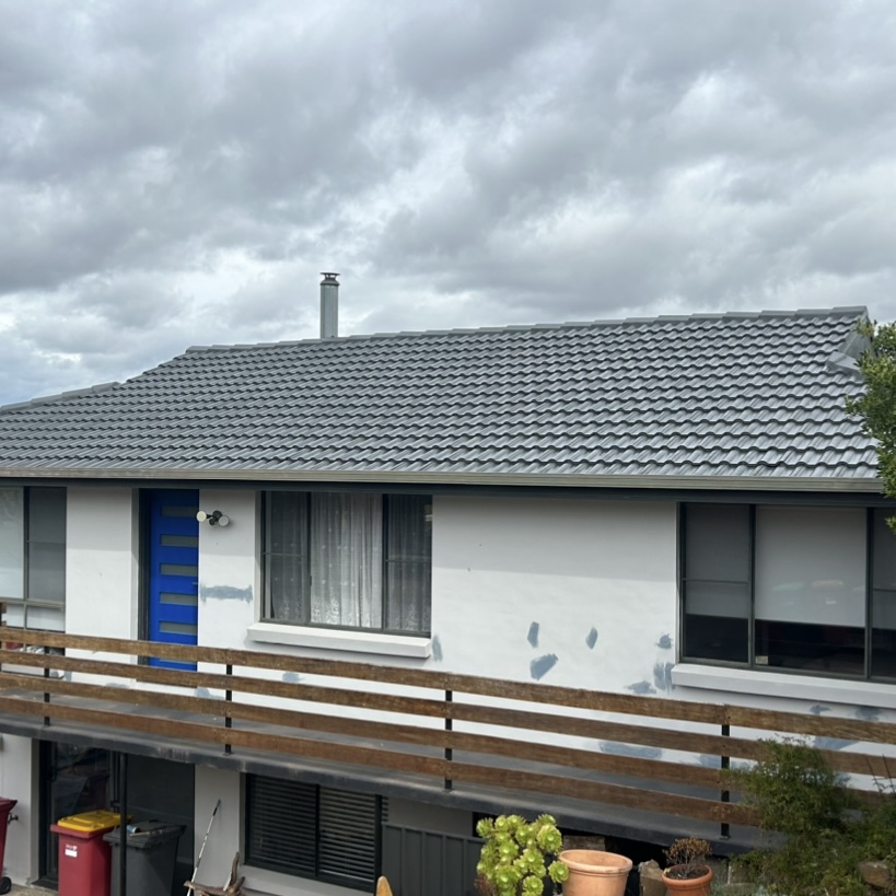 Restored grey tile roof with fresh coating